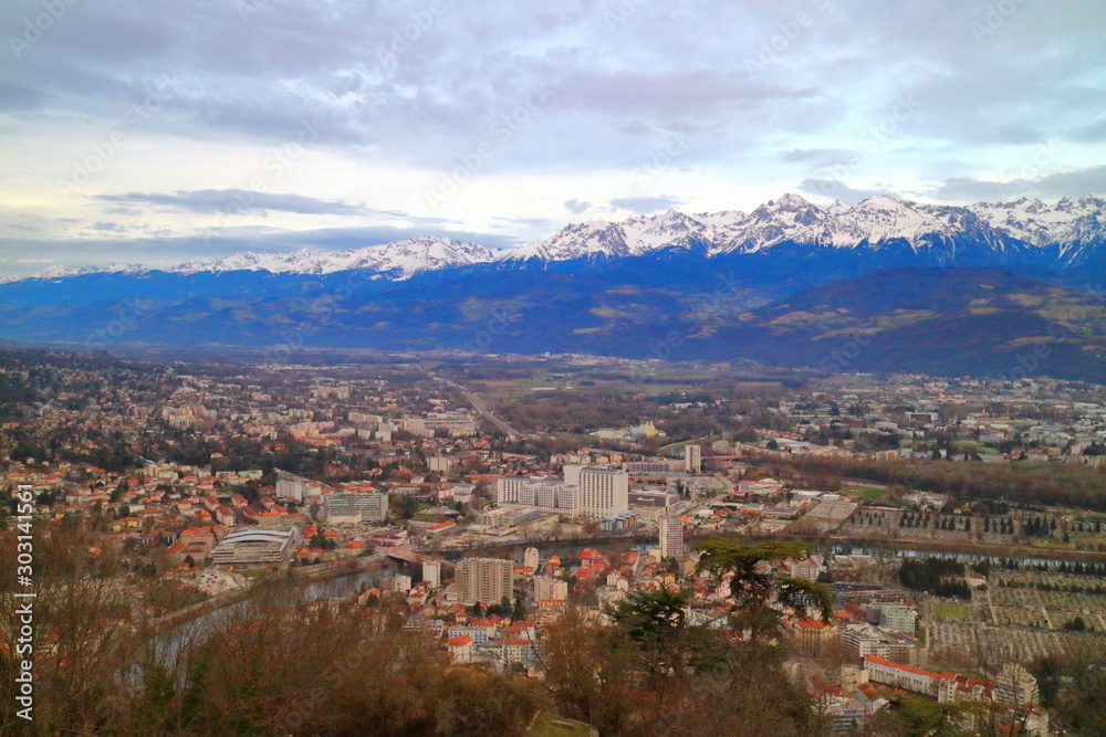 Alpes and cityscape of Grenoble city from Fort de la Bastille at dusk, France