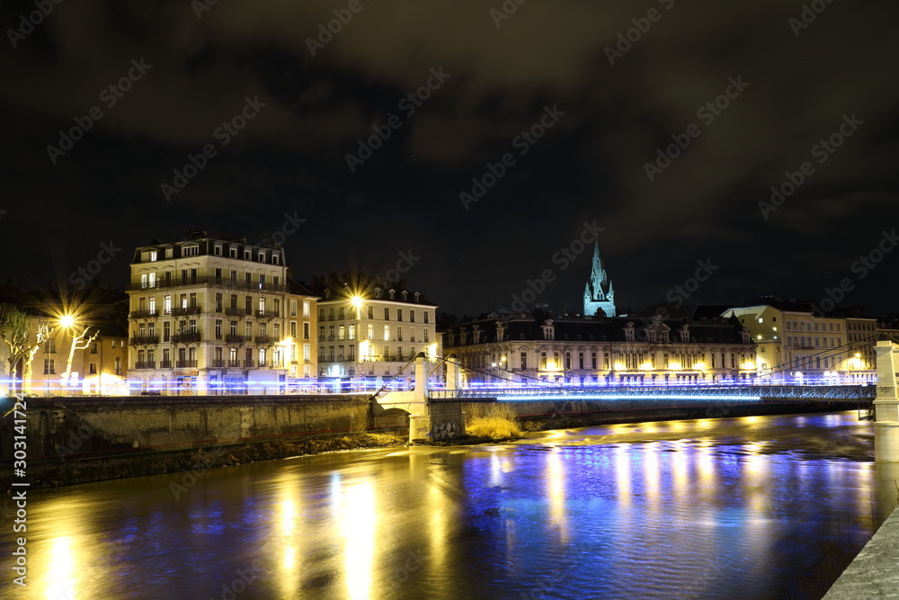 The river Isere and cityscape of Grenoble city, France at night