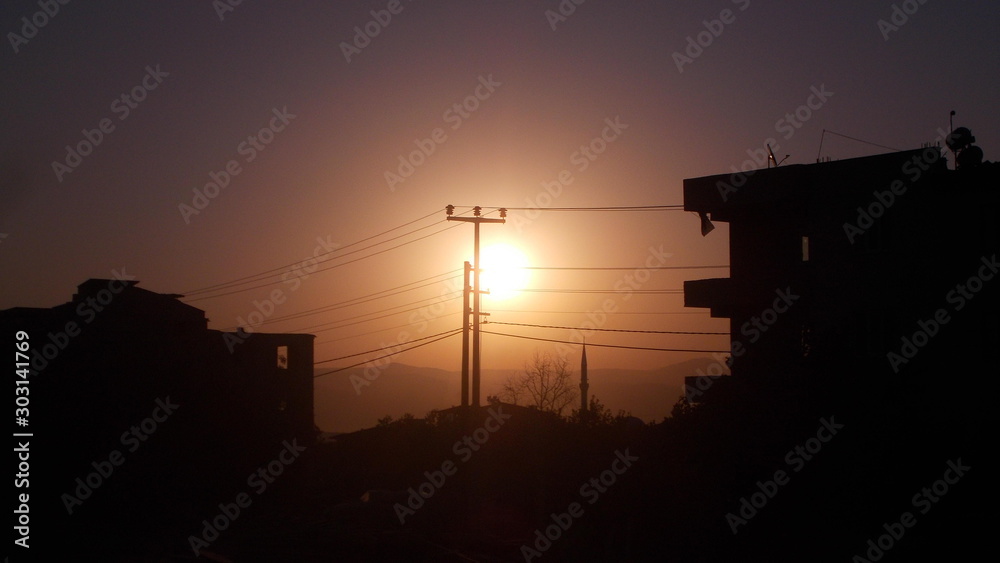 A sunrise scenery captured with buildings as silhouettes around.
