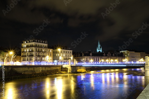 The river Isere and cityscape of Grenoble city, France at night