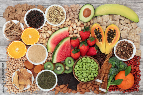 Health food for energy, vitality & fitness with fruit, vegetables, nuts, seeds, legumes, cereal  & herbal medicine.  High in vitamins, minerals antioxidants, smart carbs, protein & omega 3. Flat lay,  photo