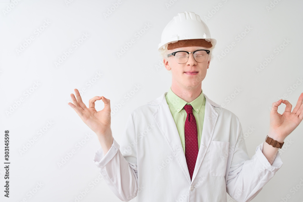 Albino scientist man wearing glasses and helmet standing over isolated white background relax and smiling with eyes closed doing meditation gesture with fingers. Yoga concept.