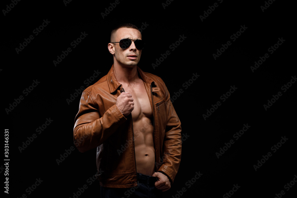 young handsome man, leather jacked on naked torso, emotional posing, lifestyle people concept