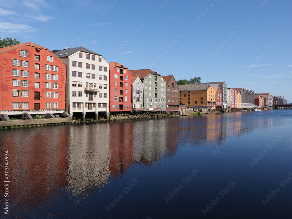 Marvelous buildings reflected in water at Nidelva river in european Trondheim city at Trondelag district in Norway