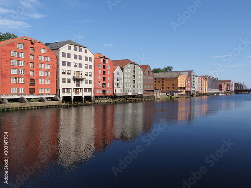Marvelous buildings reflected in water at Nidelva river in european Trondheim city at Trondelag district in Norway