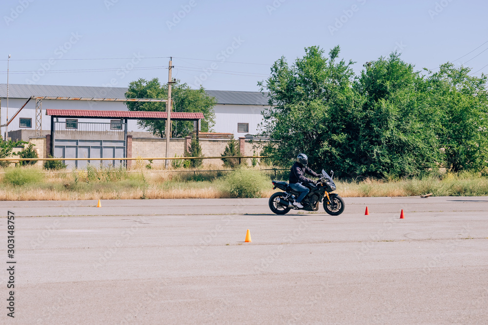 Platform for learning to drive a motorcycle. Lessons in motorcycle school. Bike driving courses for adults. Man learn to drive a bike. Improve driving skills on the training ground Stock Photo