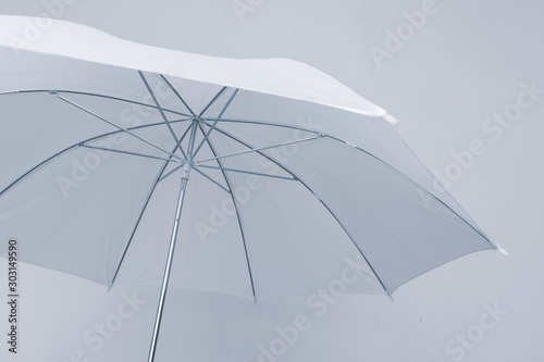 Bottom view of open white umbrella on white background