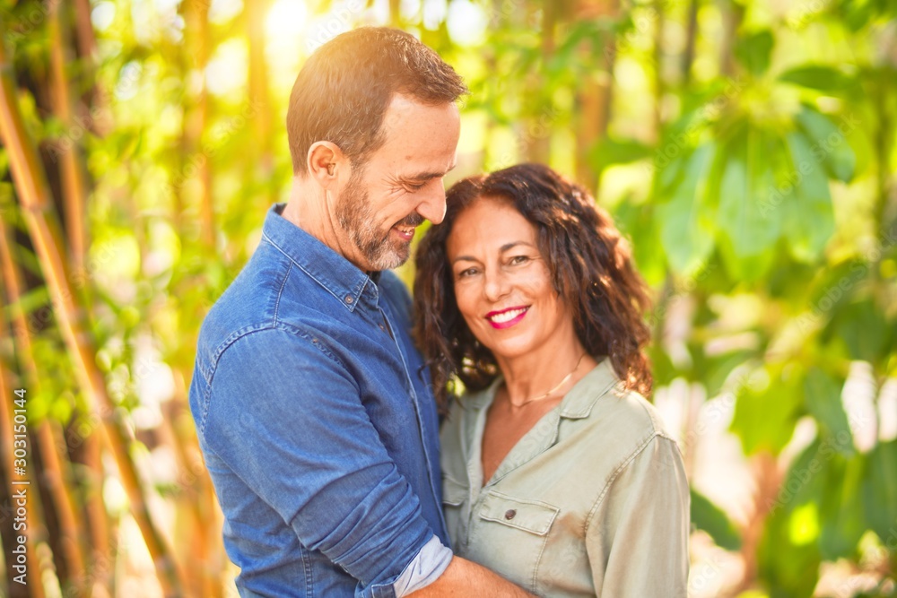 Middle age beautiful couple smiling happy and confident at town park. Standing with smile on face and hugging Middle age beautiful couple smiling happy and confident at town park. Standing with smile on face and hugging