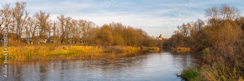 Panoramic view of the Protva River, the coastal forest and the church in Borovsk. November landscape. Kaluga region, Russia