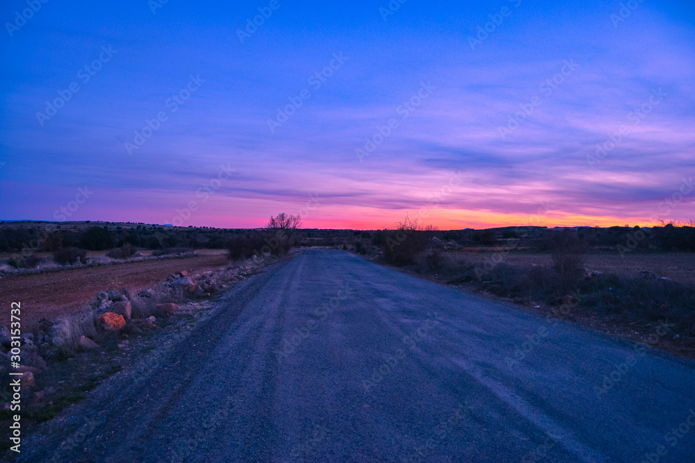 RED SUNSET LANDSCAPE ON A COUNTRYSIDE ROAD violet red colors RED SUNSET LANDSCAPE ON A COUNTRYSIDE ROAD violet red colors