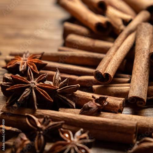 Star anise, cinnamon. Aromatic spices on wooden background. Top view. Close up. Seasoning ingredients for cooking or baking. Selective focus