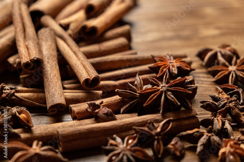 Star anise, cinnamon. Aromatic spices on wooden background. Top view. Close up. Seasoning ingredients for cooking or baking