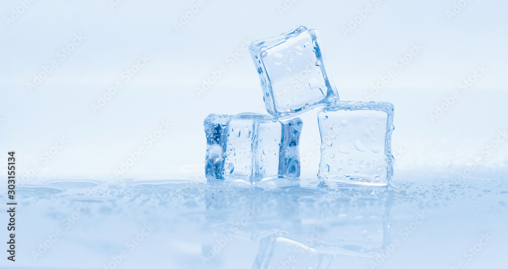 Ice cubes square with drops water clean on blue background banner Ice cubes square with drops water clean on blue background banner