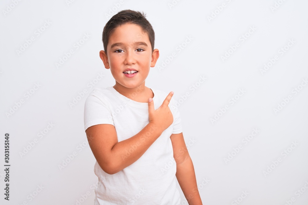 Beautiful kid boy wearing casual t-shirt standing over isolated white background cheerful with a smile of face pointing with hand and finger up to the side with happy and natural expression on face Beautiful kid boy wearing casual t-shirt standing over isolated white background cheerful with a smile of face pointing with hand and finger up to the side with happy and natural expression on face