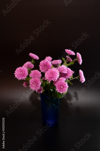  Bouquet from Chrysanthemum flower in blue vase on black background