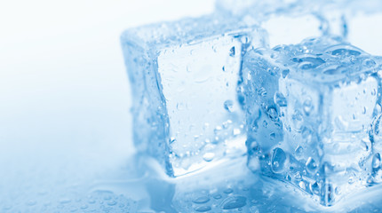 Macro photo ice cubes with drops water clean on blue background banner