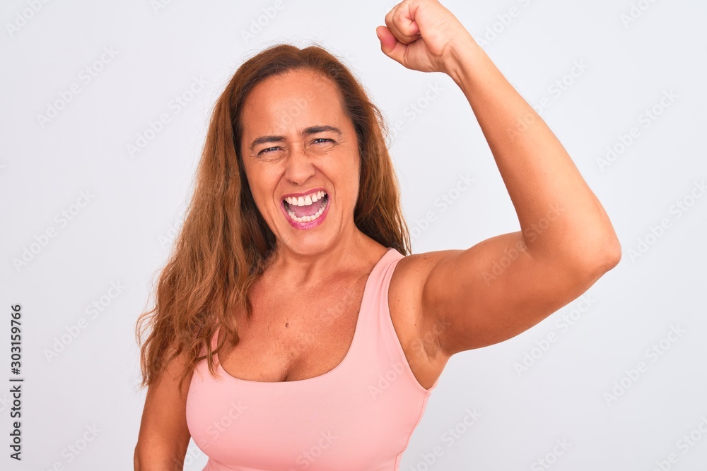 Middle age mature woman standing over white isolated background annoyed and frustrated shouting with anger, crazy and yelling with raised hand, anger concept Middle age mature woman standing over white isolated background annoyed and frustrated shouting with anger, crazy and yelling with raised hand, anger concept