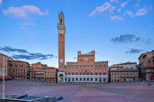 Panoramic view of the famous Piazza del Campo, Palazzo Pubblico and the Torre Del Mangia in Siena at sunset, Tuscany, Italy