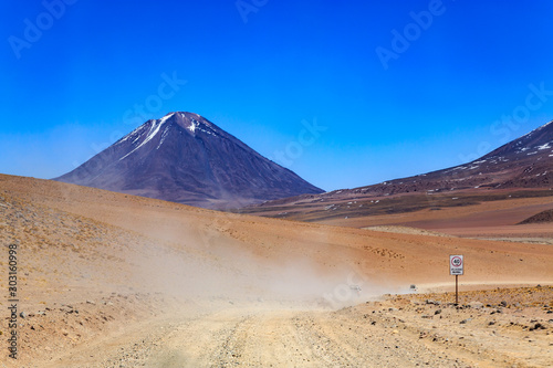 Dirt road ina landscape of the majestic Andes mountain range in Bolivia  South America