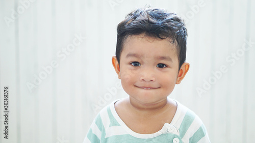 Cute happy & curious little Asian 1.6 year / 18 months old toddler baby boy child sitting in the beautiful cafe relax time on holiday Kid experience & discovery concept.