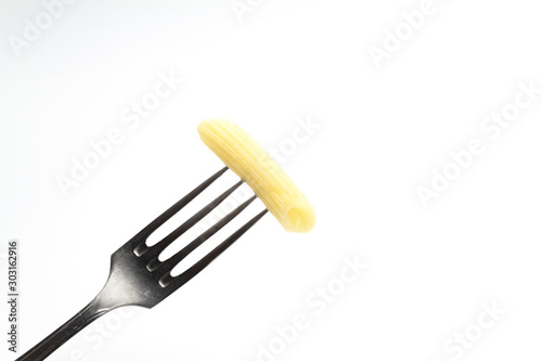 One pasta on a fork on a white background. close up