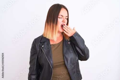 Young beautiful woman wearing t-shirt and jacket standing over isolated white background bored yawning tired covering mouth with hand. Restless and sleepiness.