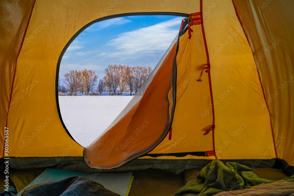 Hiking winter travel concept. View from tent - beautiful landscape of snow nature