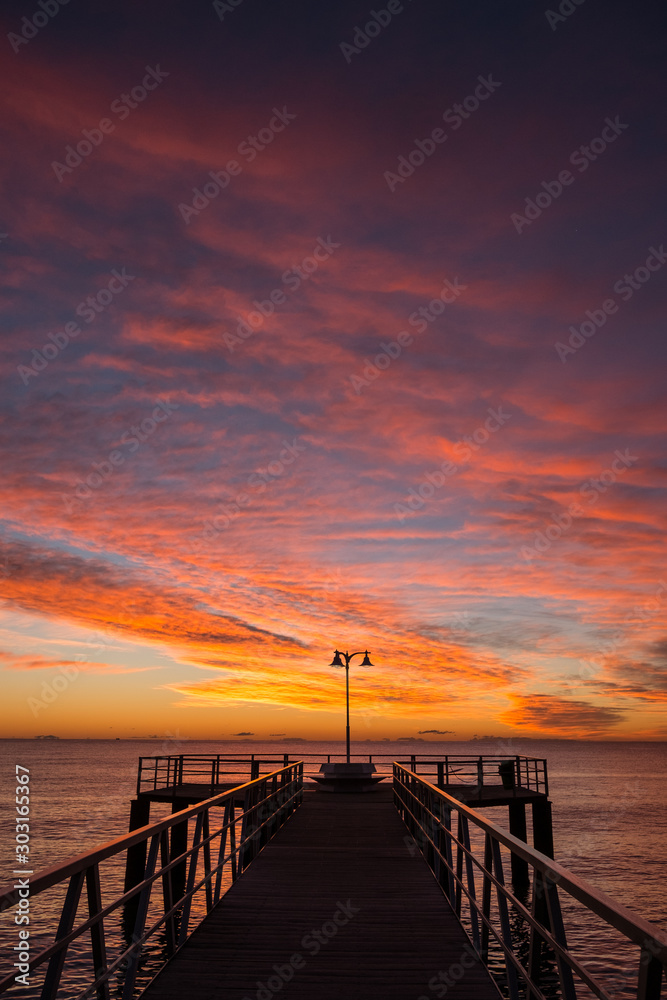 Obraz premium Image of pier over the Mediterranean sea at sunrise