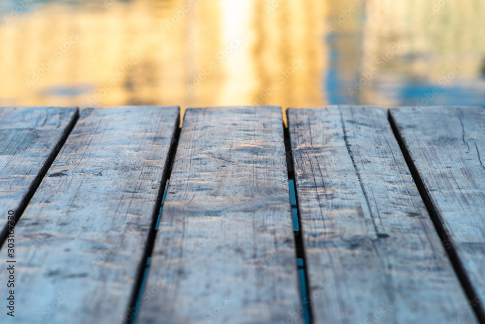 Wooden planks marine pier in front of abstract sea background. Wooden planks marine pier in front of abstract sea background.