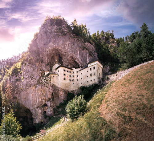 Beautiful predjama castle, Slovenia. Panorama of the castle at the cave in Postojna in summer. Predjamski grad.  photo
