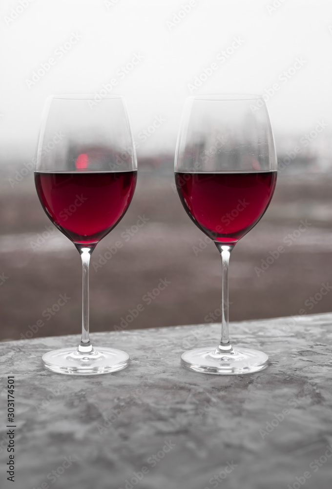 glasses of red wine on the grey background 