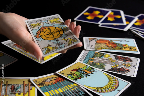 Bangkok,Thailand,november.13.19. Tarot cartomancy. Cards for divination on a black background with the reflection of the moon. Divination for Christmas. Fortune-telling and the future. photo