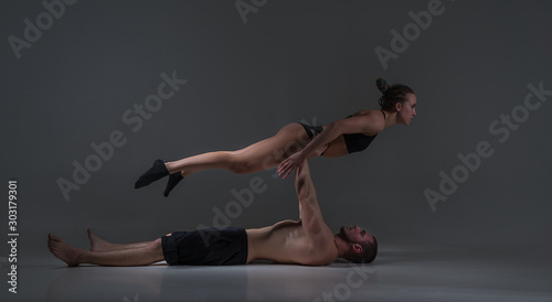 a pair of acrobats make complex shapes.