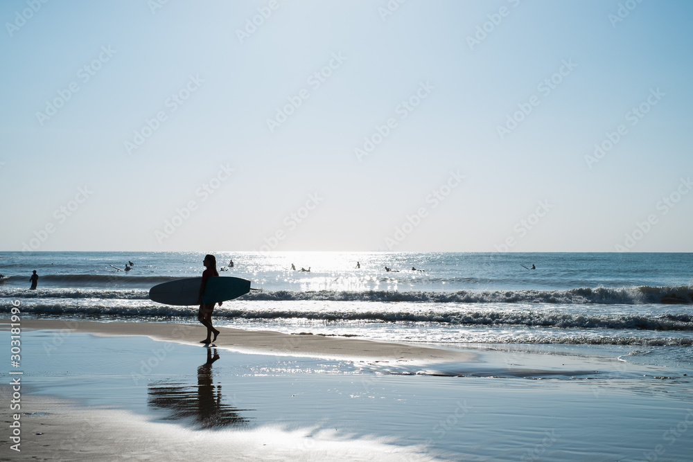  surfer silhouette on a beach of the Mediterranean sea