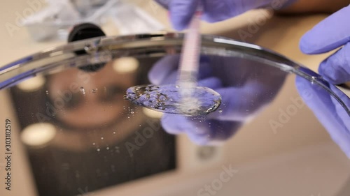 Experiment with hyaluronic acid and hyaluronidase mixing and blanding it togather on the mirror surface. photo