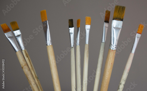 Various paint brushes on the grey background. Artist Paintbrushes Set.
