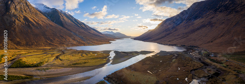 aerial panorama of glen etive and loch etive in the argyll region of the highlands of scotland during autumn and a golden sunset