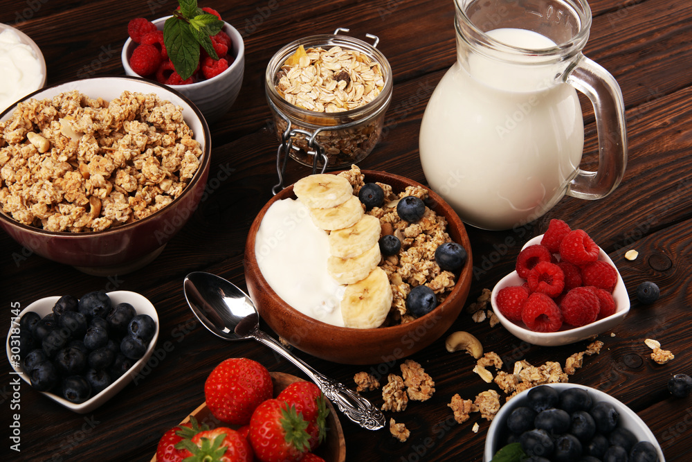 Tasty homemade granola served on table. Healthy breakfast with a bowl of oatmeal with banana, blueberries, strawberries and healthy food for Breakfast