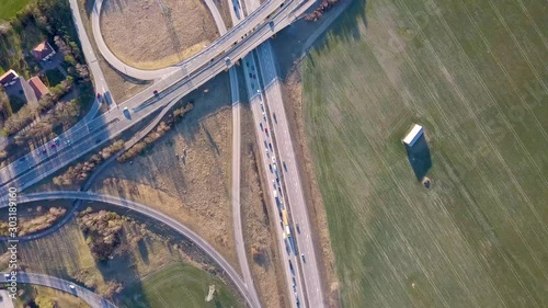 Top down aerial view of highway intersection with moving traffic cars.  photo