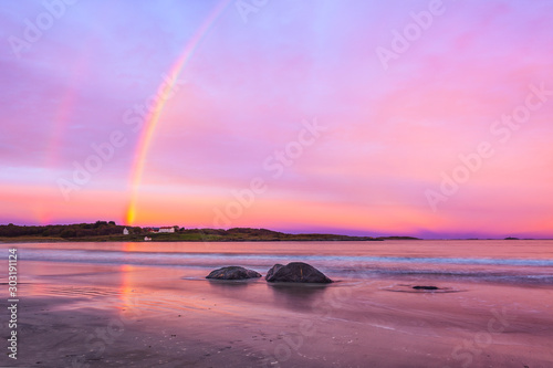 rainbow over beach at farstad in norway