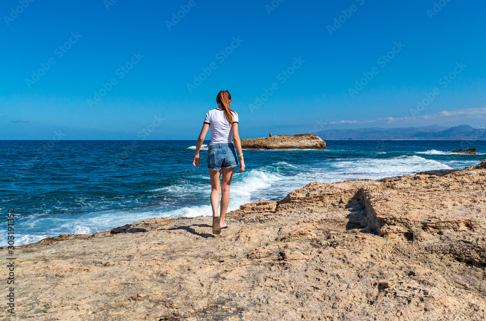 Young girl in sea coastline on Crete near Hersonissos