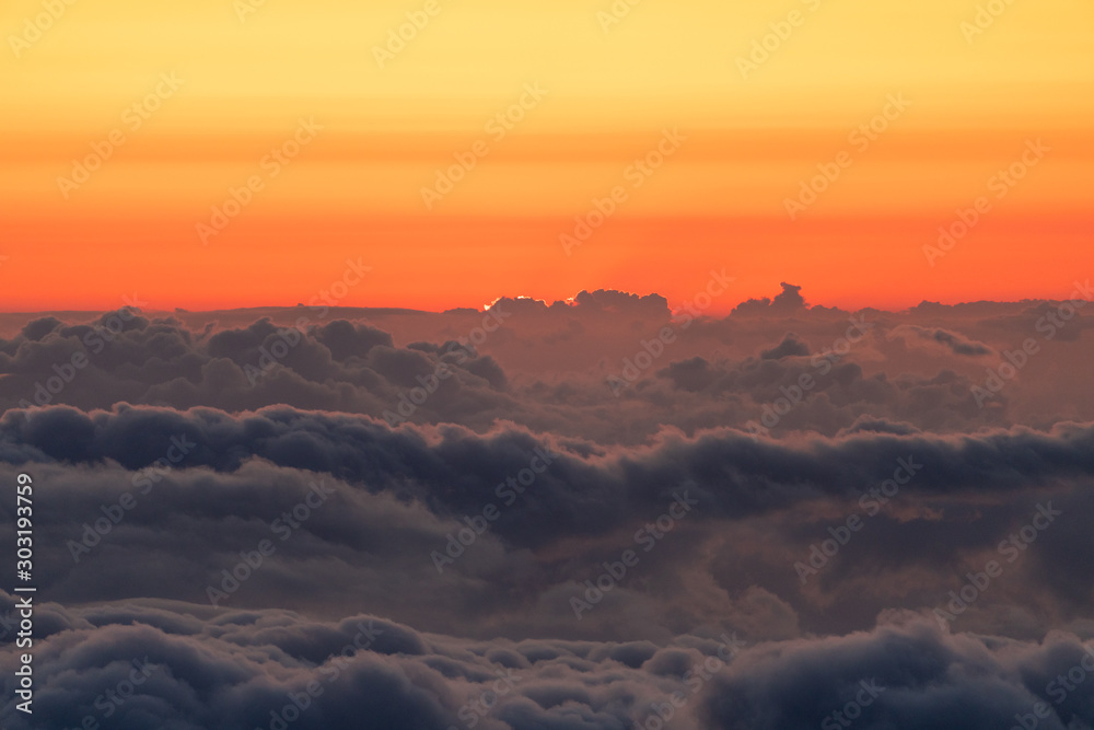 Beautiful colorful dramatic sunset above clouds from Haleakala National Park.