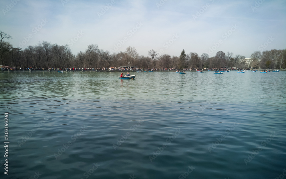 Lake of the Retiro Park ( Porque del Retiro )in Madrid with people paddling in boats   