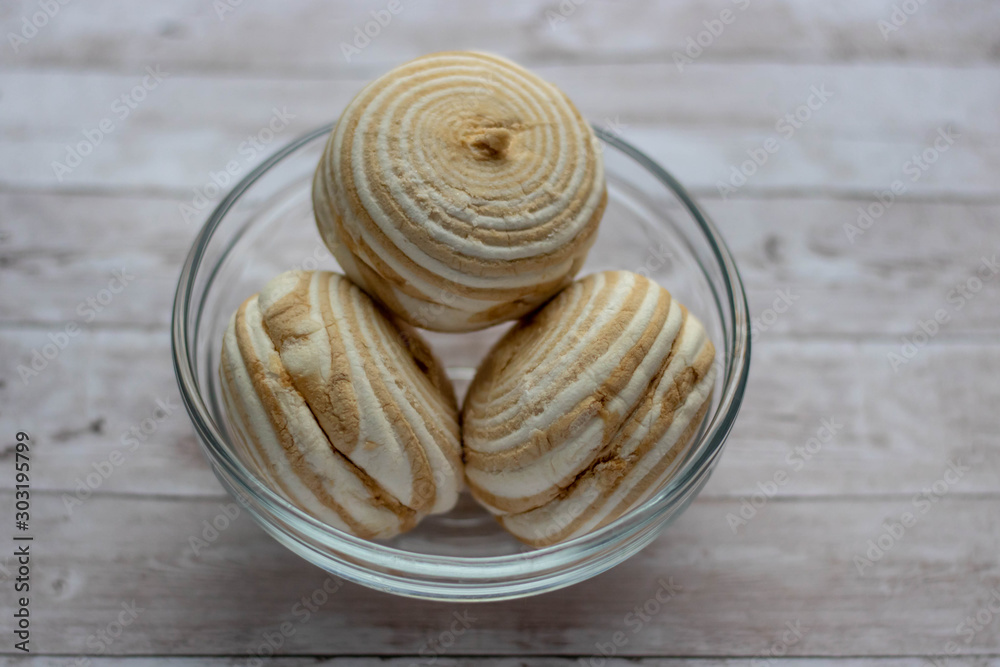 Vanilla marshmallow zephyr with caramel on a wooden table. Selective focus. Copy space Vanilla marshmallow zephyr with caramel on a wooden table. Selective focus. Copy space
