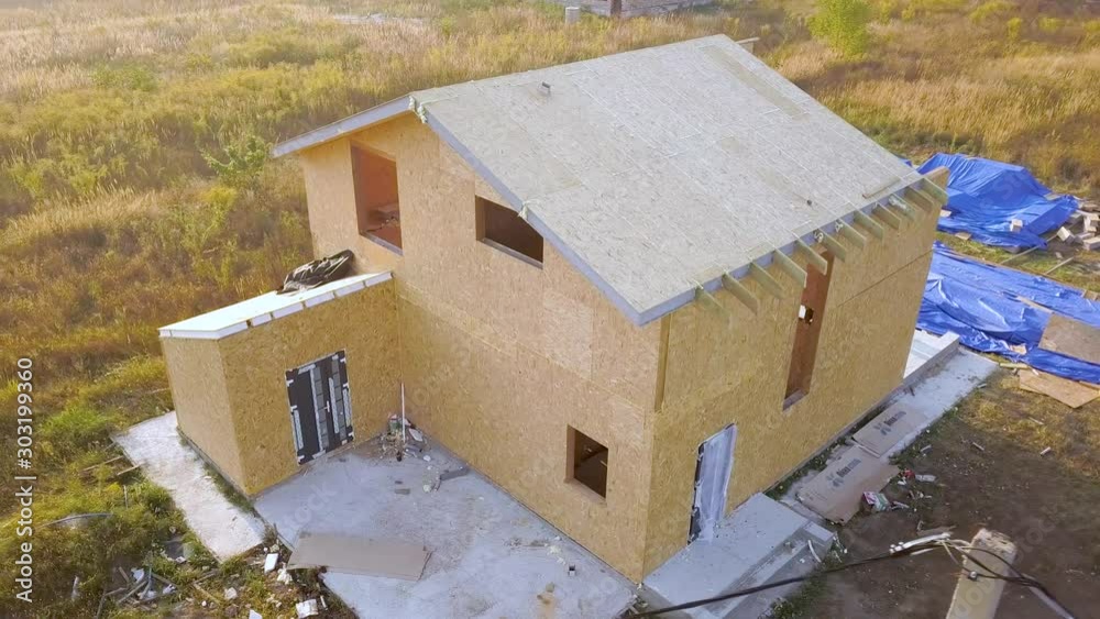 Construction of new and modern modular house. Walls made from composite wooden sip panels with styrofoam insulation inside. Building new frame of energy efficient home concept.