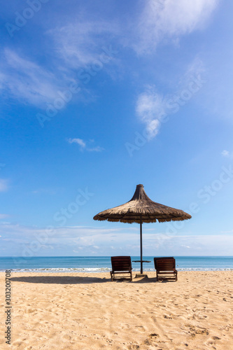 Back view of Sun bed in a beach on a sunny day © Thusitha