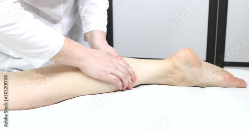 Technique of sports and wellness foot massage. Close-up shot in a beauty salon.