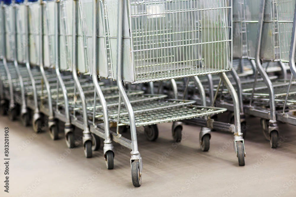 Row of shopping carts at supermarket entrance Row of shopping carts at supermarket entrance