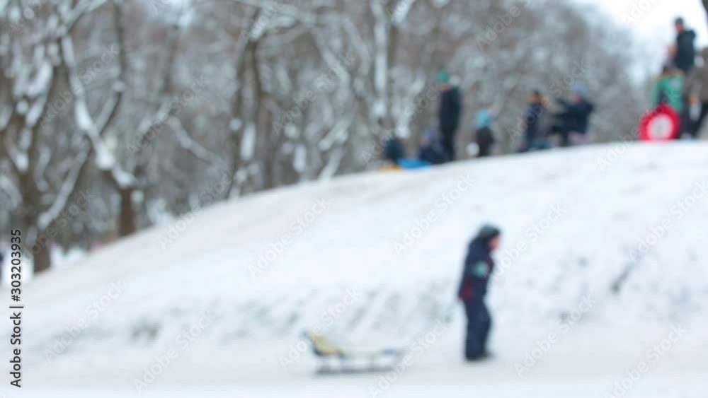 Blurry defocused winter slide and many people having fun at snowy hills. Real time full hd video footage. Blurry defocused winter slide and many people having fun at snowy hills. Real time full hd video footage.
