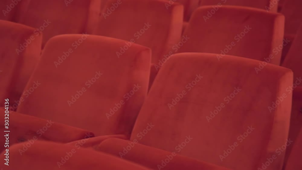 course of blank movie seats Empty theater hall. Rows of empty armchairs seats in cinema theatre Red seats before movie. Movie entertainment concept course of blank movie seats Empty theater hall. Rows of empty armchairs seats in cinema theatre Red seats before movie. Movie entertainment concept